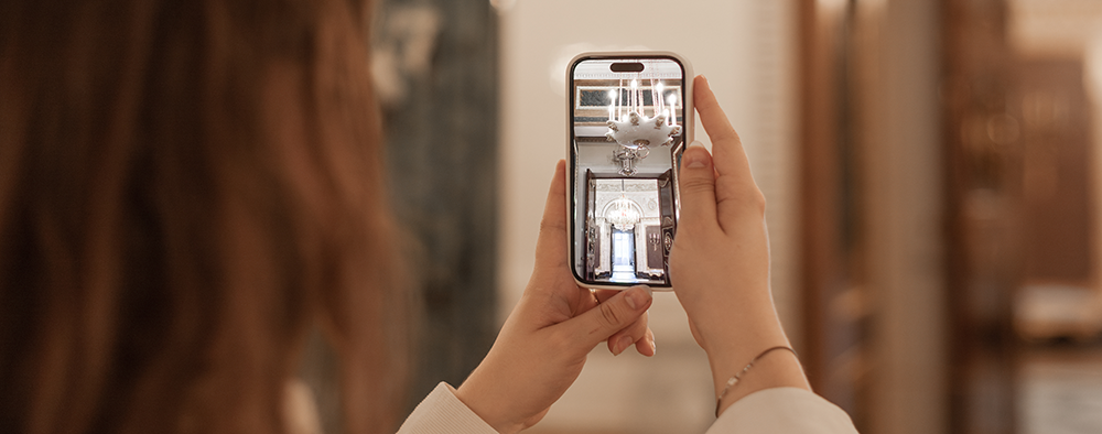 woman taking a phone pic of her home